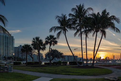 Sun shining over Miami Beach bayfront at sunset, USA