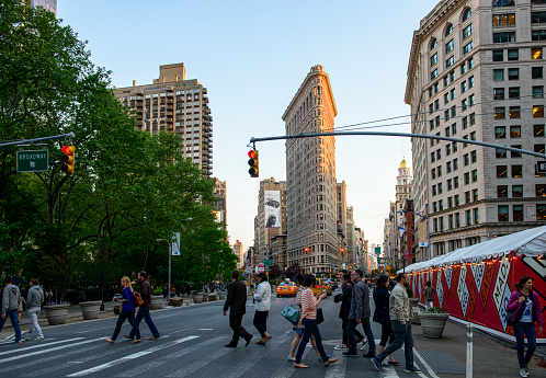 New York City, New York, USA - May 20, 2014: Crowd of people crossing the street at 23rd Street, Fifth Avenue, and New Broadway, New York