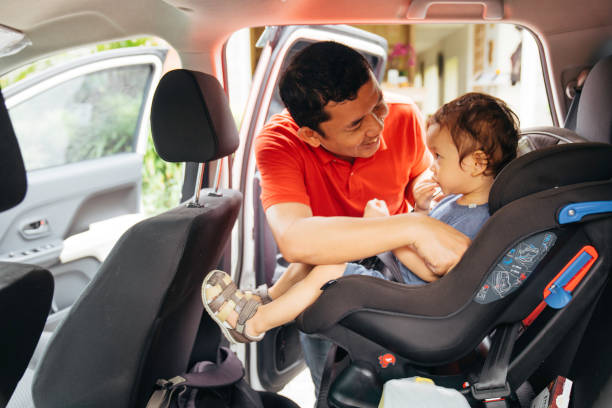 istock A young father strapping his baby into a car seat 1470857856