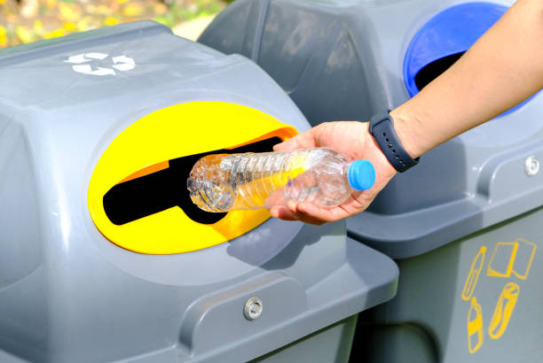 istock Please throw plastic bottles in the bin. Man littering the bins by separating waste for disposal such as recyclable plastic waste. environmental concept 1470862376