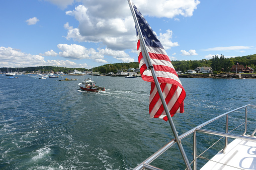 Fishing boat and United States flag in Boothbay Harbor, Maine