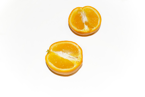 Orange on white - bright halves of citrus. Two halves of an orange on a white background.
