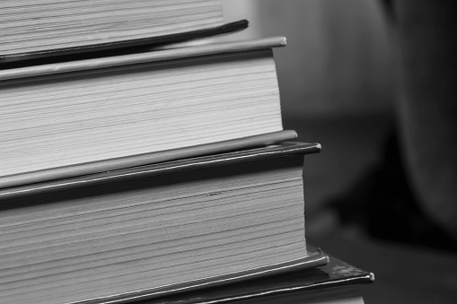 A stack of books. Photos in black and white. books stacked on top of each other - shooting up close.