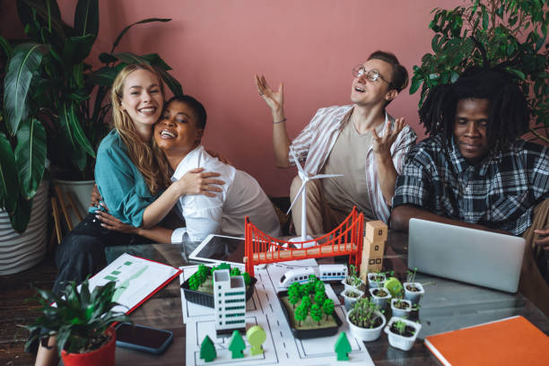 istock International diverse group of students working on modern urban architecture project with renewable green energy source, alternative electricity, waste recycling. Brainstorming ideas, business plan 1470868490