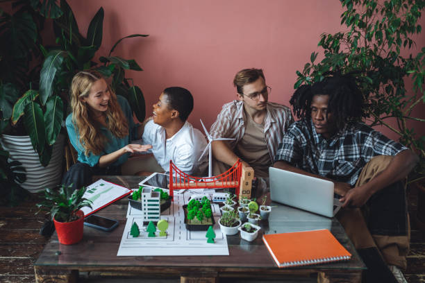 istock International diverse group of students working on modern urban architecture project with renewable green energy source, alternative electricity, waste recycling. Brainstorming ideas, business plan 1470868491