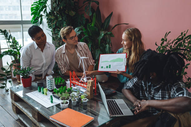 istock International diverse group of students working on modern urban architecture project with renewable green energy source, alternative electricity, waste recycling. Brainstorming ideas, business plan 1470868525