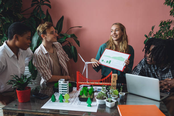 istock International diverse group of students working on modern urban architecture project with renewable green energy source, alternative electricity, waste recycling. Brainstorming ideas, business plan 1470868535