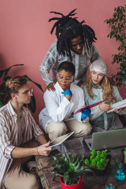 istock International group of diverse multiracial students working on the biological project, creating new species of plants and flowers. Ecological environmental university college study, experiment, test 1470868897