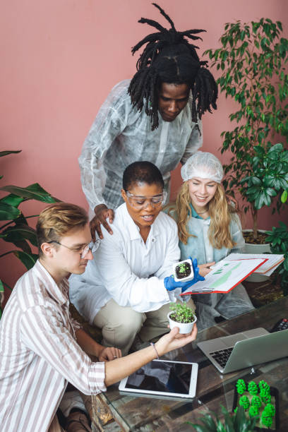 istock International group of diverse multiracial students working on the biological project, creating new species of plants and flowers. Ecological environmental university college study, experiment, test 1470868906