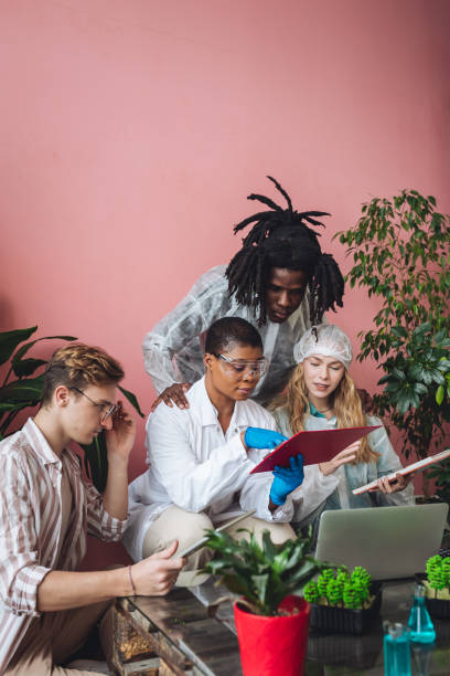 istock International group of diverse multiracial students working on the biological project, creating new species of plants and flowers. Ecological environmental university college study, experiment, test 1470868907