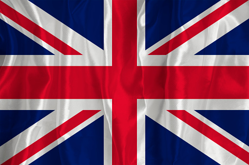 The flag of Britain on a silk background is a great national symbol. Fabric texture The official state symbol of the country. Background with British flag