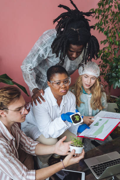 istock International group of diverse multiracial students working on the biological project, creating new species of plants and flowers. Ecological environmental university college study, experiment, test 1470868924