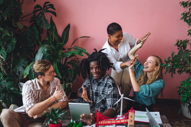 istock International diverse group of students working on modern urban architecture project with renewable green energy source, alternative electricity, waste recycling. Brainstorming ideas, business plan 1470869679