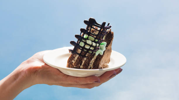 istock Chocolate cake on a white plate in female hands 1470871616