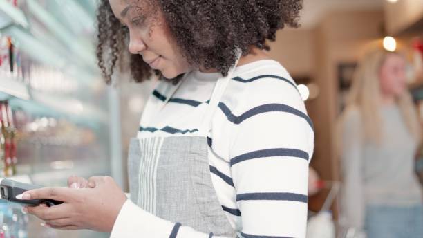 istock African American worker working in supermarket, use barcode scanners or handheld checking the number of products left on the shelf in shopping mall. Employee or head of fruit and vegetable department inspecting the quality of products sold on shelf. 1470871640