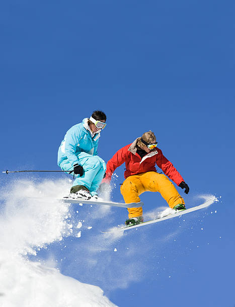 Snowboarder Against Ski Jumper stock photo