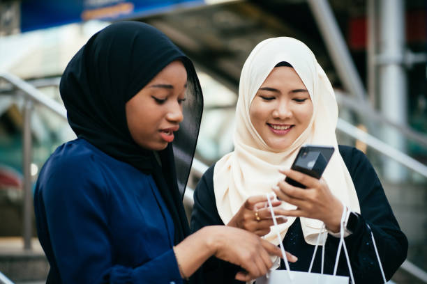 istock Two muslim women looking at a mobile phone 1470873572