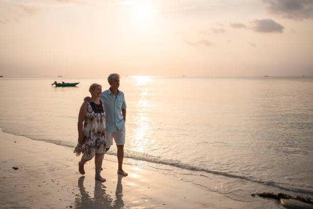 istock Senior couple takes a leisurely beach walk 1470873911