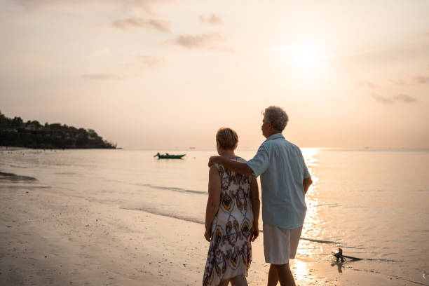 istock Senior couple takes a leisurely beach walk 1470873913