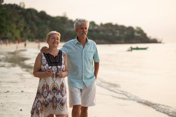 istock Senior couple takes a leisurely beach walk 1470873919