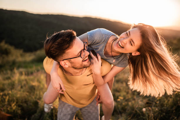 istock Young cheerful couple having fun while piggybacking in nature. 1470878670