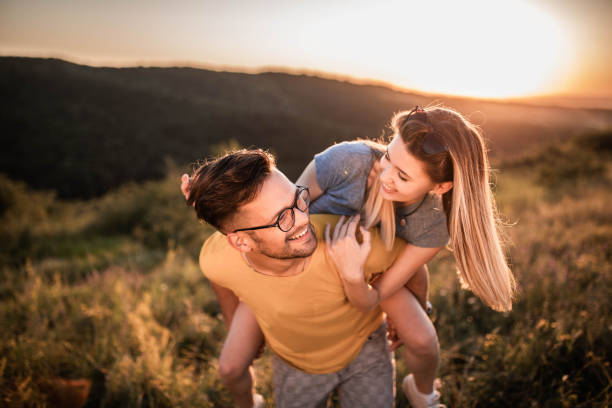 istock Playful couple having fun while piggybacking in springtime. 1470878700