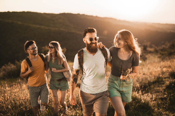 istock Happy couple and their friends taking a walk on a hill. 1470878730