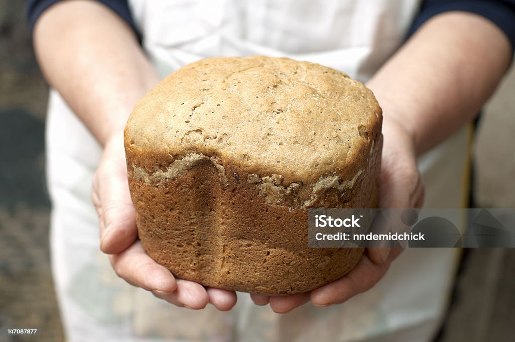 Hands of woman baker with homemade bread Adult Stock Photo