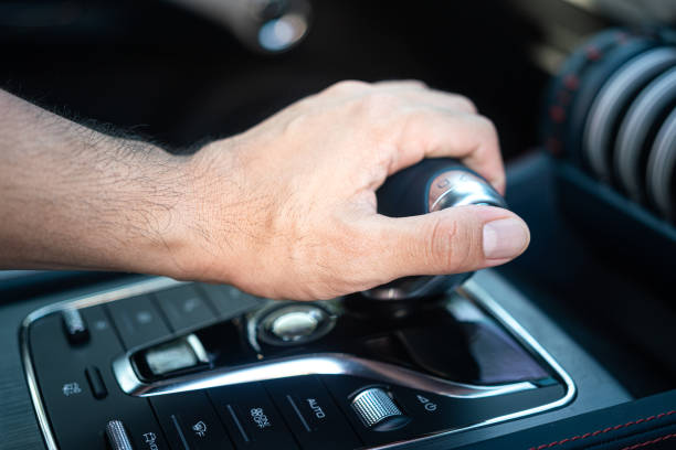 istock Driver shifting the car gear's shifter. 1470879477