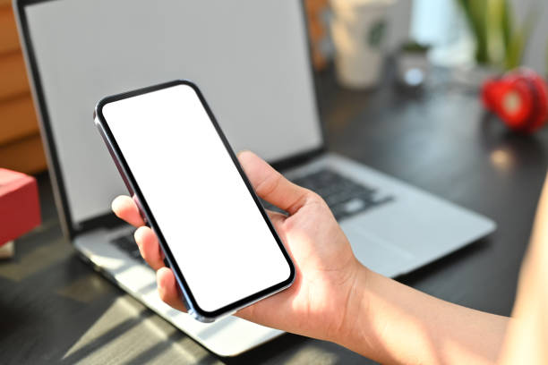 istock Woman hand holding mobile phone with white blank display, empty screen for graphic display montage. 1470879826