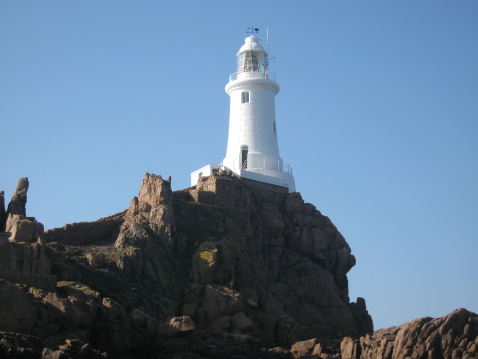 a pristine white lighthouse on the Island of Jersey in the Channel Isles