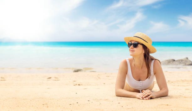 istock Woman lying on the sea beach 1470884059