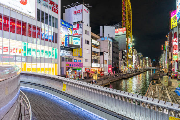 Osaka, Japan - 02 February, 2023. A winter night shot on Dotonburi street shopping in Osaka, Japan. Crowded People walking around at the Dotonburi road. Dotonburi is the district is known as one of the main shopping and tourism areas in Osaka,Japan.