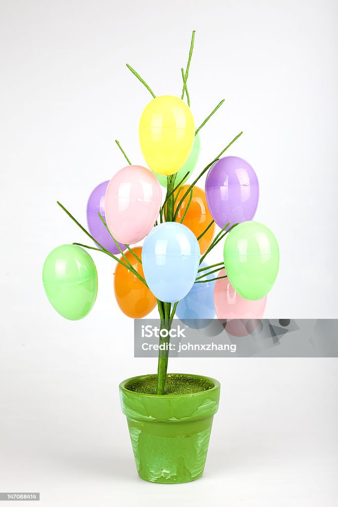Easter egg tree Colorful easter eggs hanging on a fake tree planted in a pot. Animal Egg Stock Photo