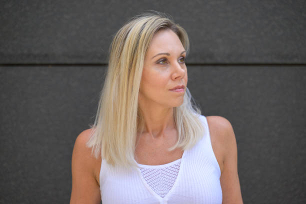 istock Attractive blond woman looking away wih a pensive expression 1470886190