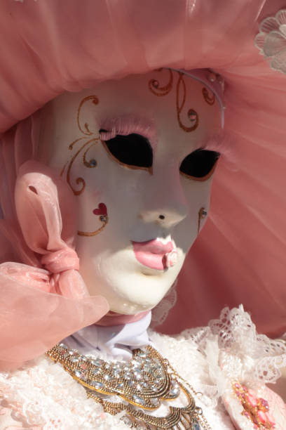 Burano, Venice, Italy - February, 18, 2020: Traditional Venice Carnival in Venice, Italy. People wearing masks and colorful costumes at the carnival