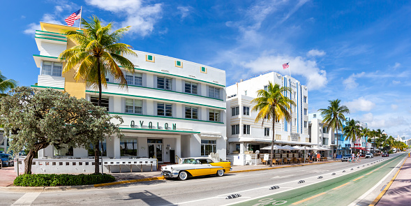 Miami Beach, United States - November 15, 2022: Avalon Hotel in Art Deco architecture style and classic car panorama on Ocean Drive in Miami Beach Florida, United States.