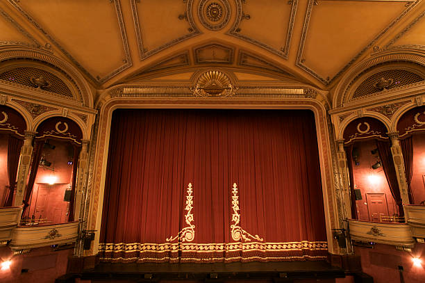 istock A classy fancy theater stage with a close red curtain 147088895