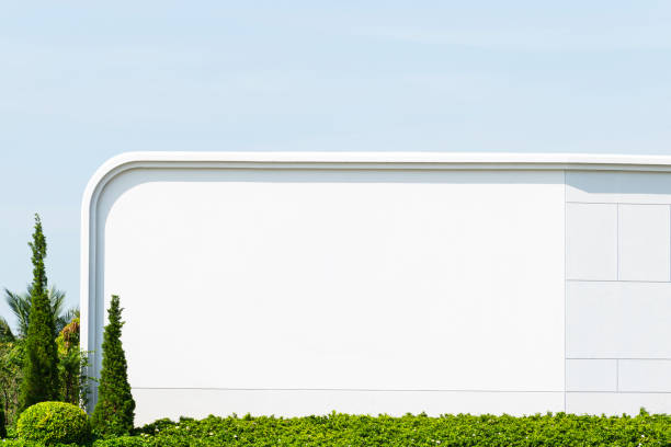 istock White concrete wall with bush wall on blue sky background 1470889054