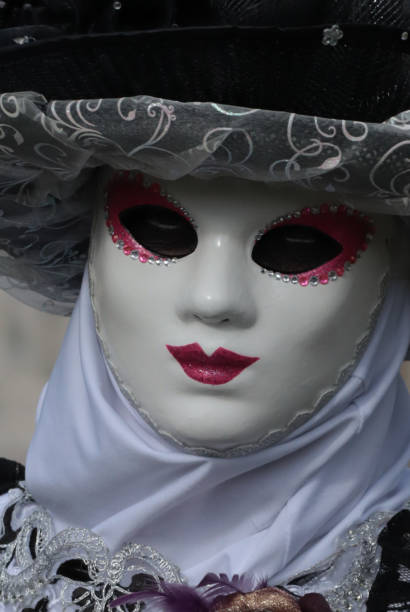 Venice, Italy - February 8, 2024: The Carnival of Venice (Italian: Carnevale di Venezia) is an annual festival held in Venice, Italy, famous throughout the world for its elaborate costumes and masks. The Carnival ends on Shrove Tuesday (Martedì Grasso or Mardi Gras), which is the day before the start of Lent on Ash Wednesday (February-March).\nThe Carnival traces its origins to the Middle Ages, existing for several centuries until it was abolished in 1797. The tradition was revived in 1979, and the modern event now attracts approximately 3 million visitors annually.