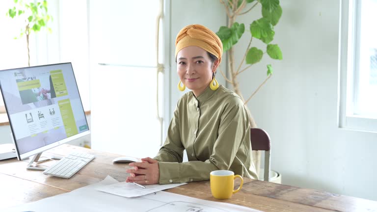 A confident, mature woman in turban leading company.