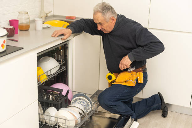 istock Male Technician Sitting Near Dishwasher In Kitchen 1470890761