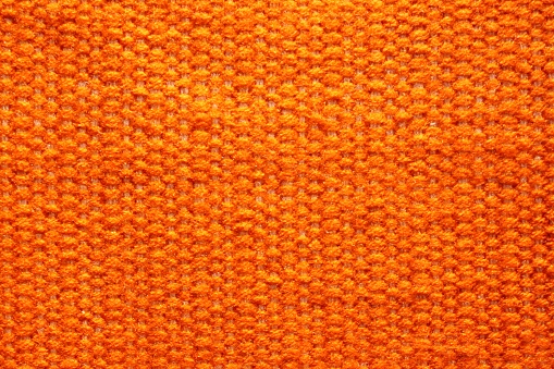 Woven wool fabric texture. Hand knitted textile canvas background. Patchwork carpet backdrop. Factory material threads. Abstract design. Close-up, mockup, top view