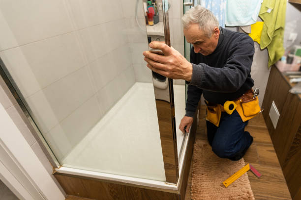 istock an elderly man is repairing a shower cabin 1470892361