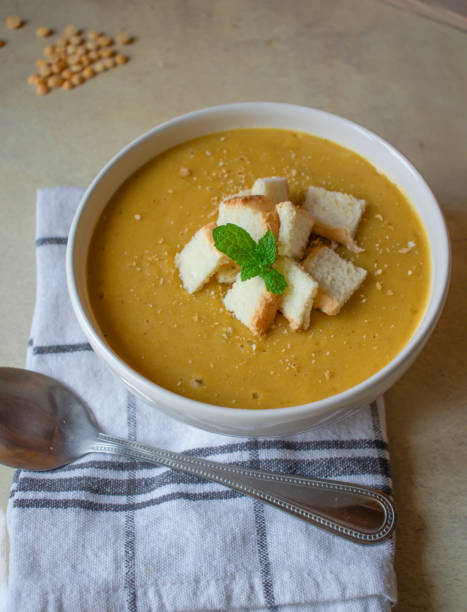 istock Pea soup in a white plate with crackers. lunch. 1470892399