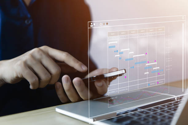 istock Manager managing business planning project schedule in office showing Gantt chart on virtual screen 1470893789