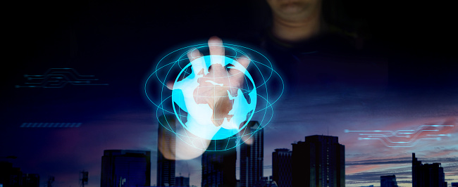 businessman holding world graphic hologram for economic technology and finance information data access in futuristic internet connection network concept on digital city background