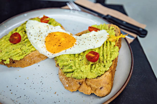 istock Classical breakfast close up toasts with avocado and sunny side egg 1470896472
