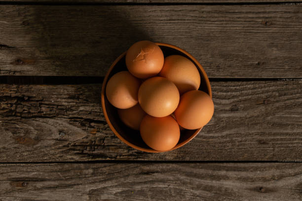 istock yellow chicken eggs on old wooden table table 1470898757