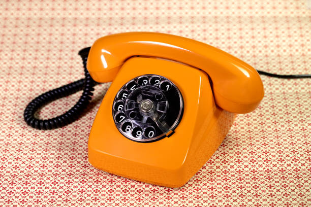 старый оранжевый телефон - obsolete landline phone old 1970s style стоковые фото и изображения